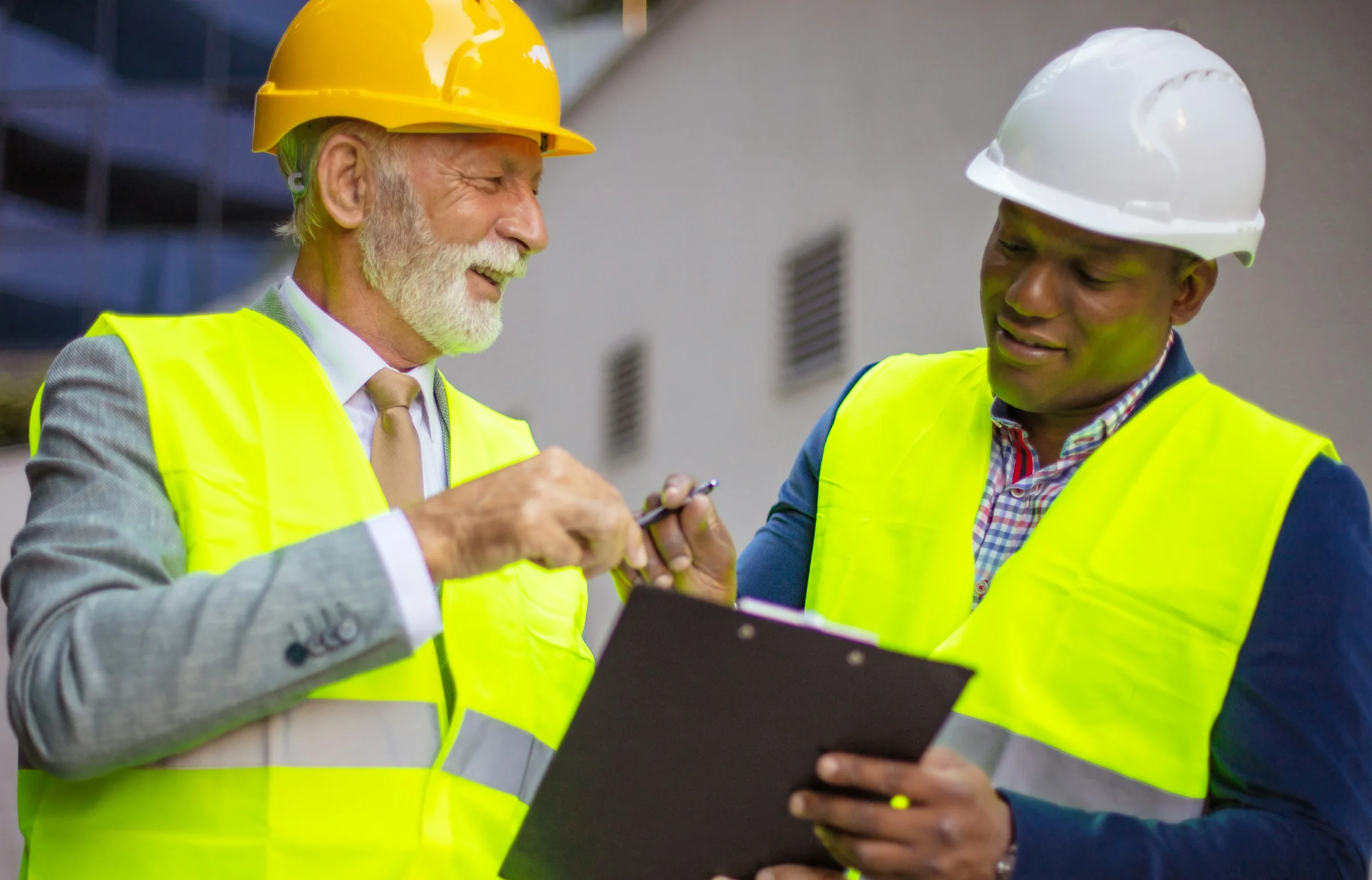 Construction workers manually analyzing timesheet data.
